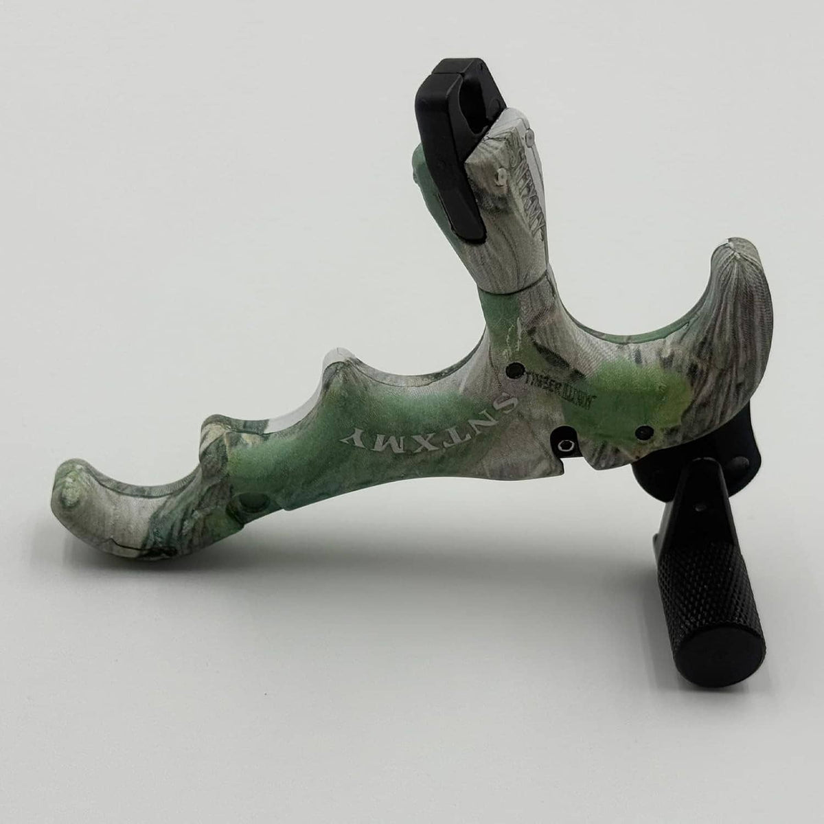 Green camo bow trigger release with black textured grip and round thumb trigger