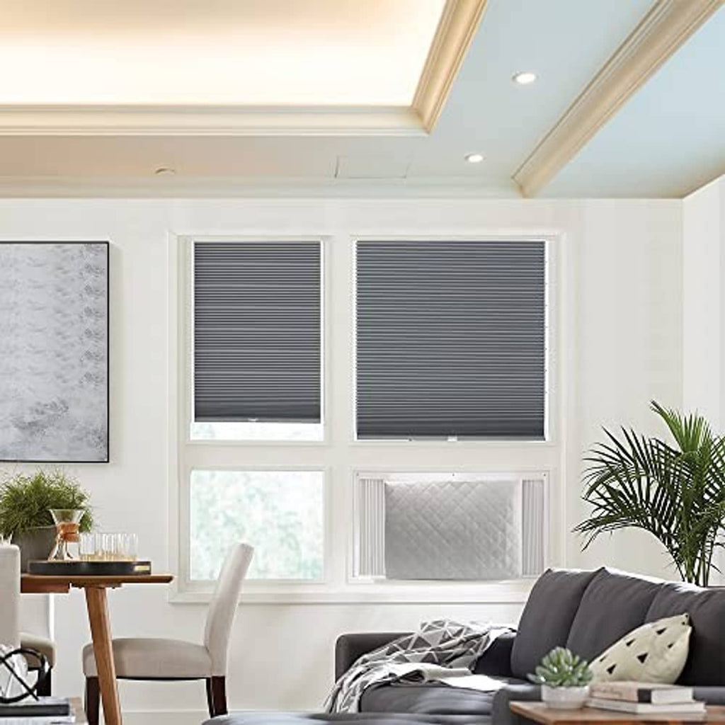Light gray quilted air conditioner cover installed over window unit