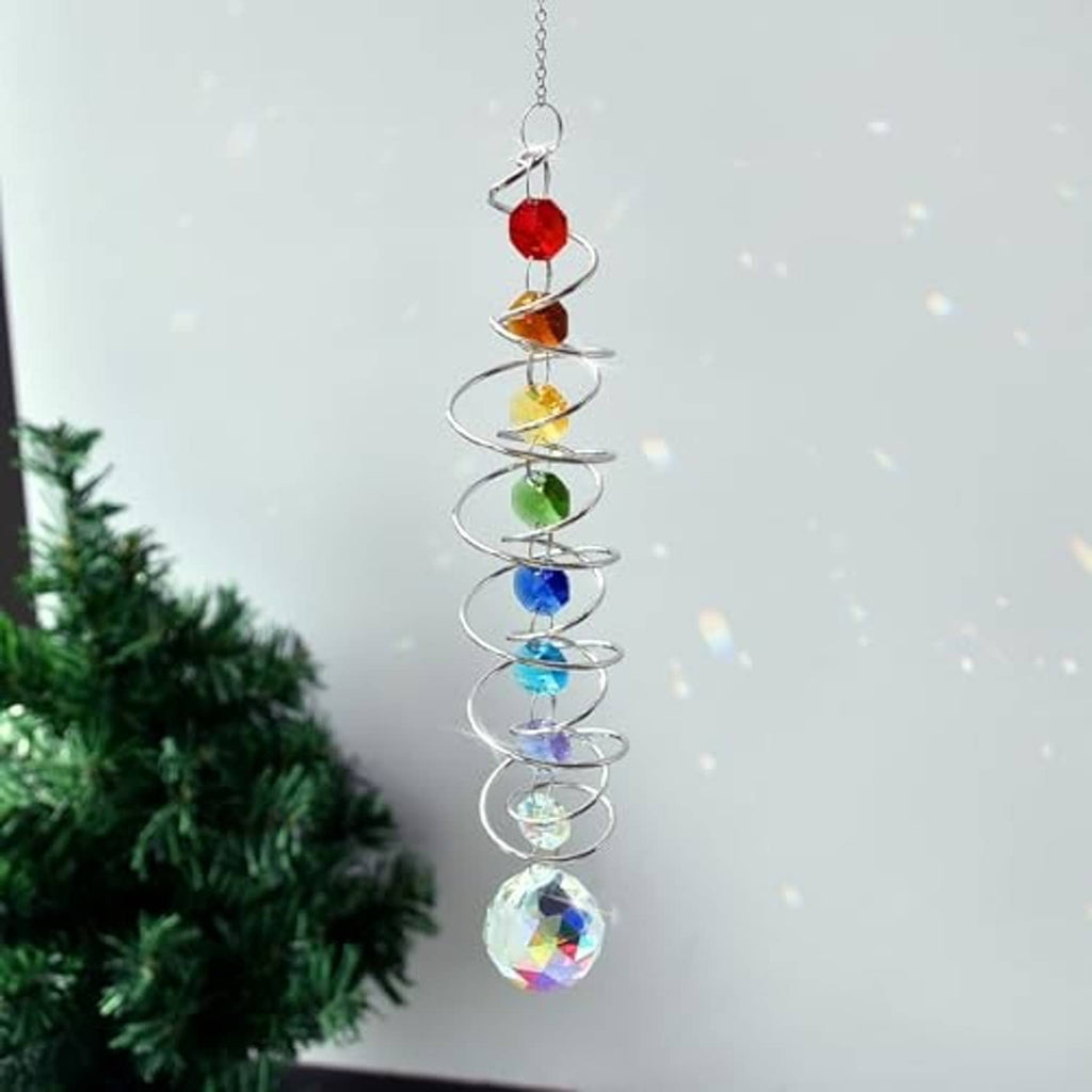 Hanging rainbow crystal wind spinner with spiral metal coil, colored beads, and faceted prism ball.