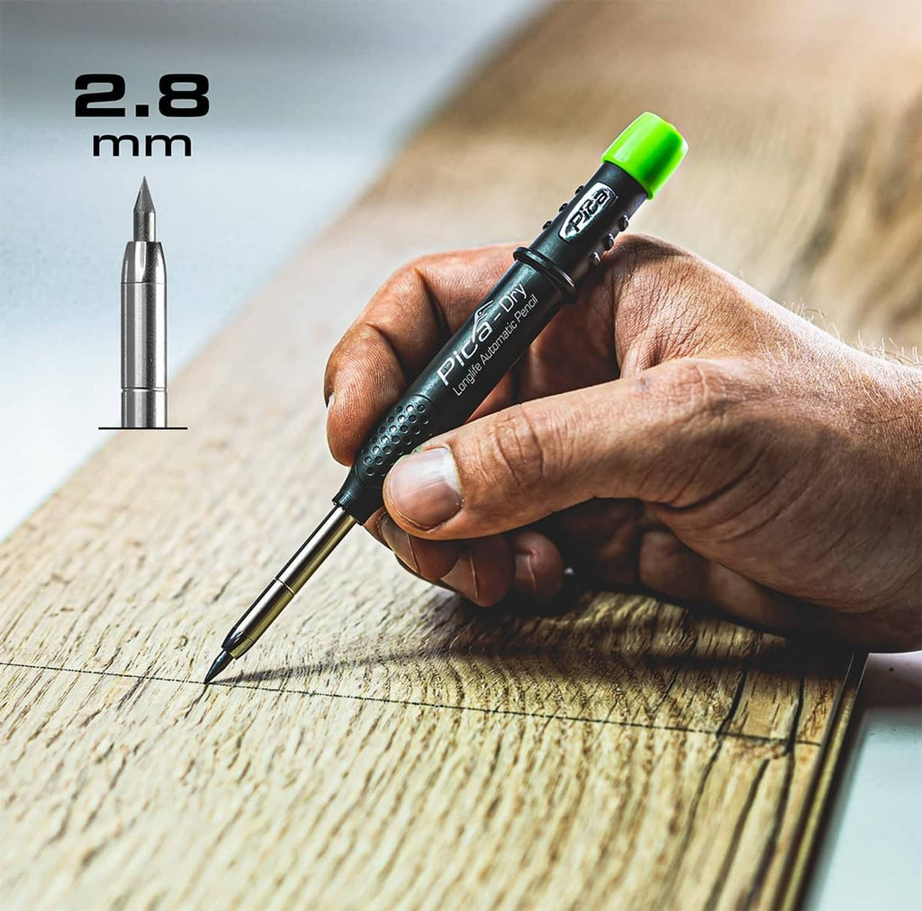Automatic pencil writing on wood board; fine metal tip visible
