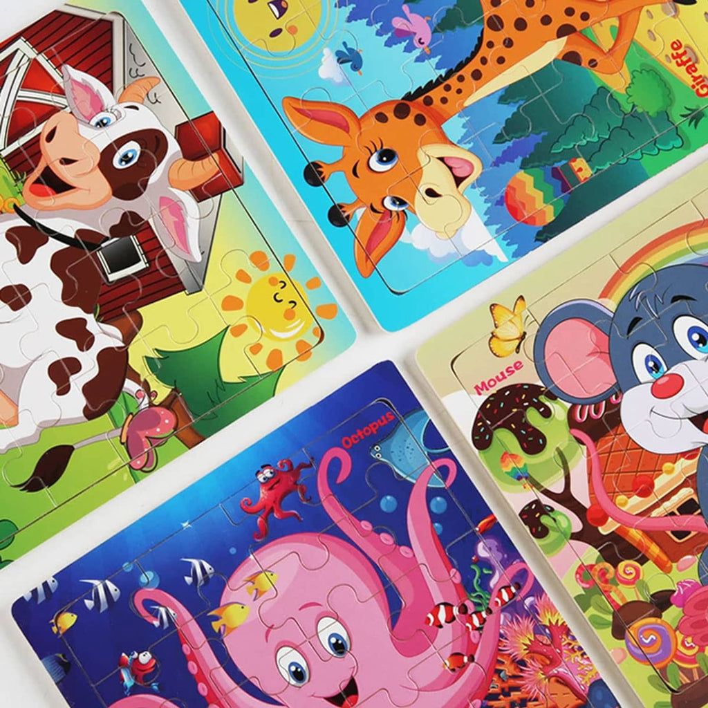 Assorted animal jigsaw puzzle pieces spread in a cross pattern