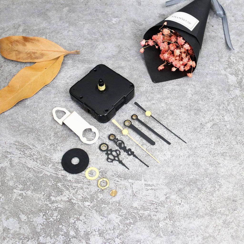 Black clock movement base with gold pin and included clock hand and washer parts