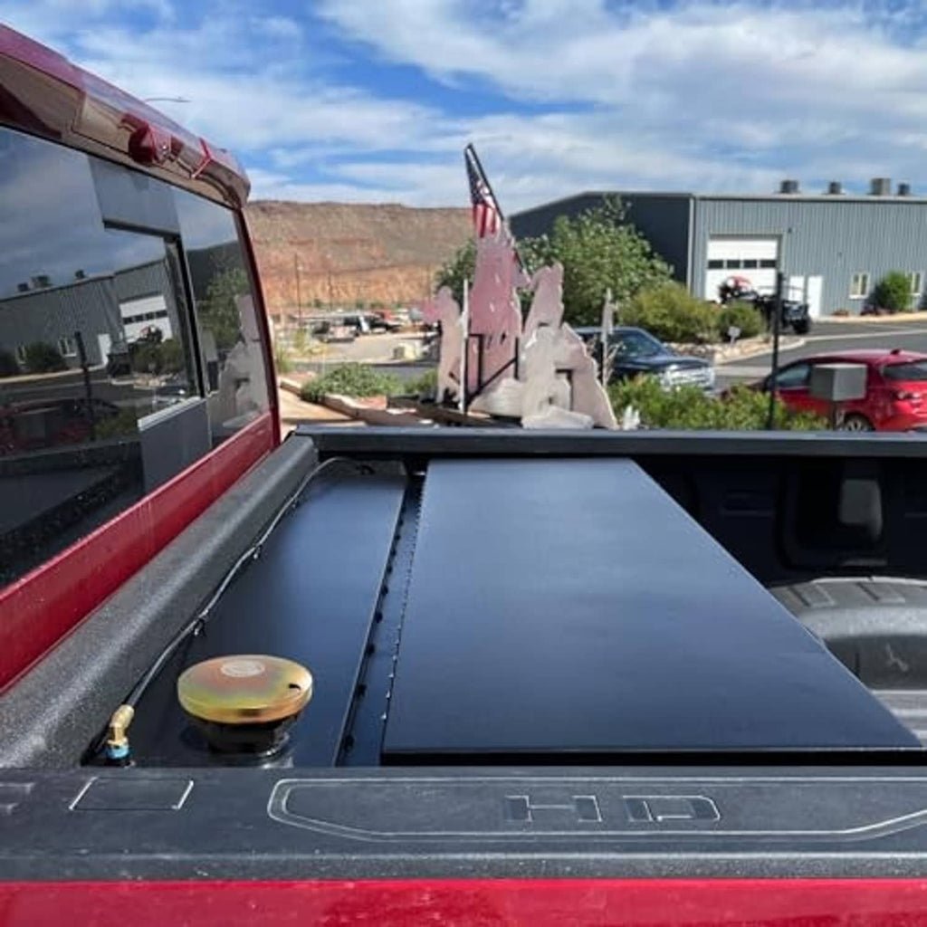 Truck bed fuel cap area with vented cap and gold-toned top on threaded base
