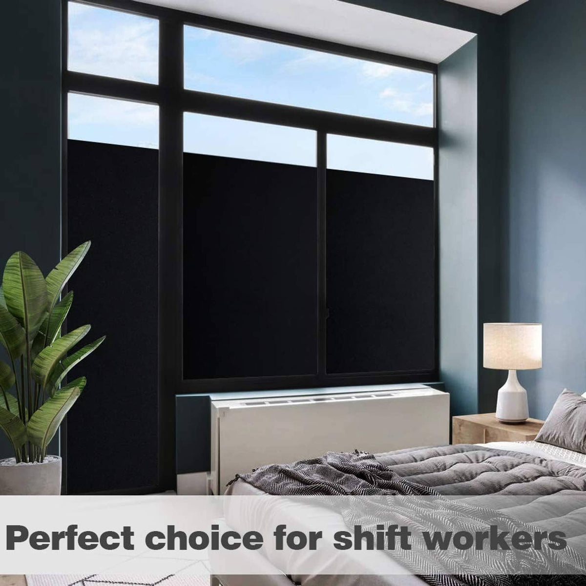 Black blackout window film covering window panes for privacy, dark matte finish
