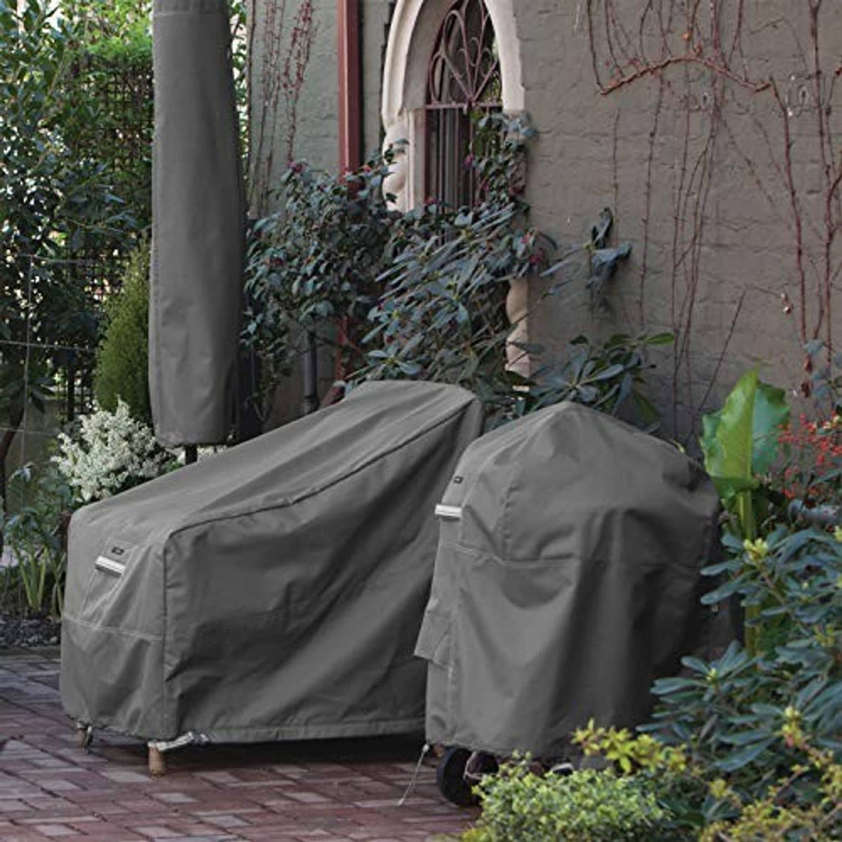 Two dark gray square air conditioner covers with smooth top panels outdoors