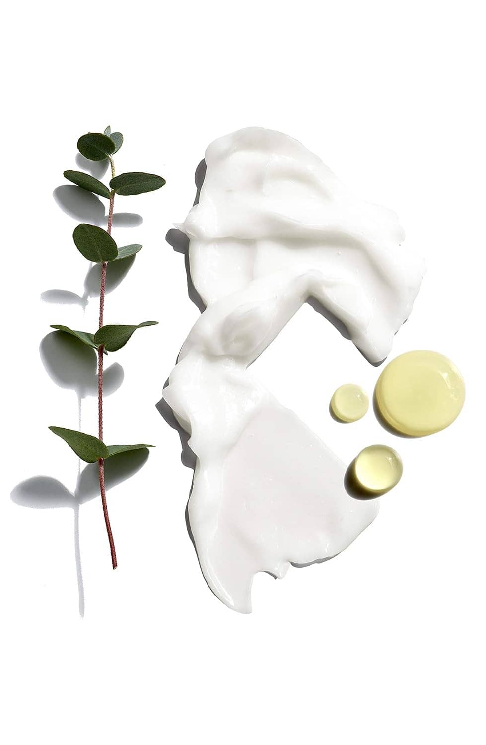 White beard conditioning cream swirl with green sprig and small yellow oil capsules