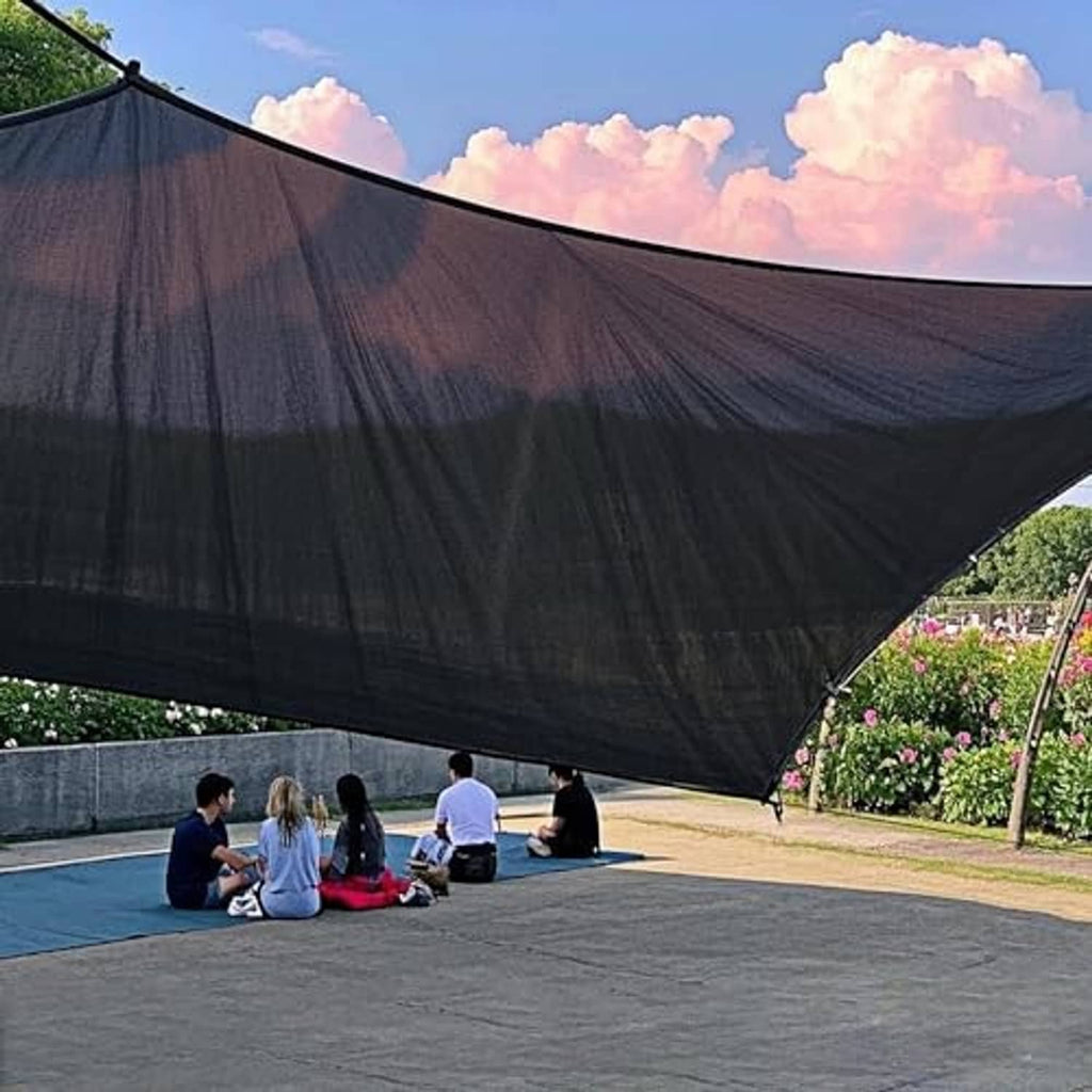 Black mesh shade cloth tarp canopy draped over outdoor seating area