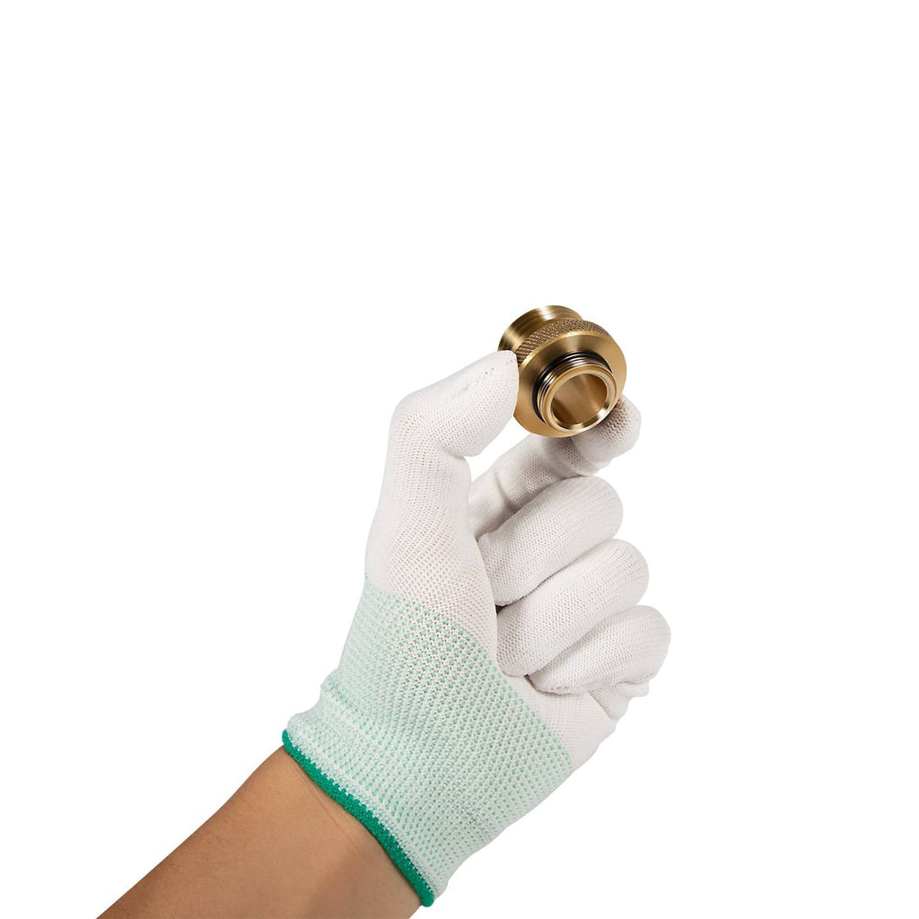 Brass hose bibb adapter held by gloved hand, showing connector end and threads