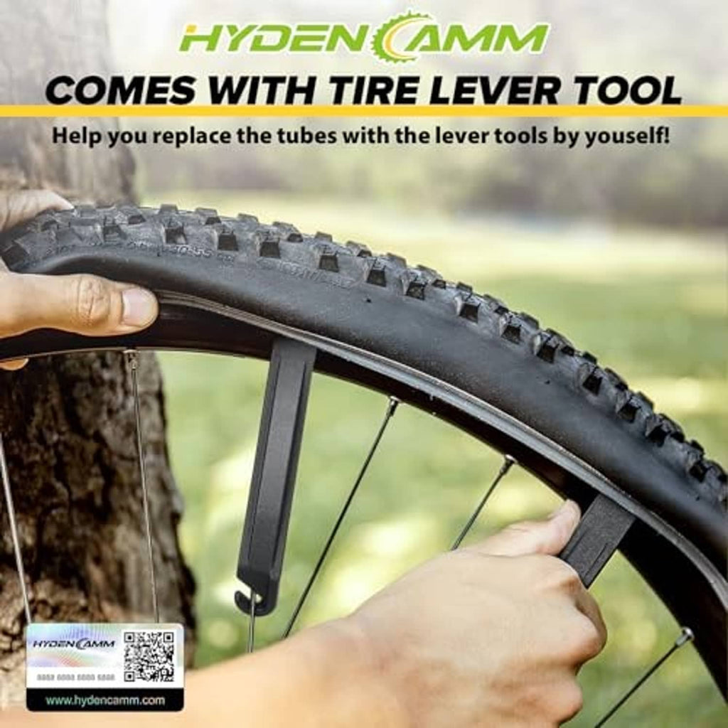 Bicycle tire lever tool with inner tube replacement near tire tread.