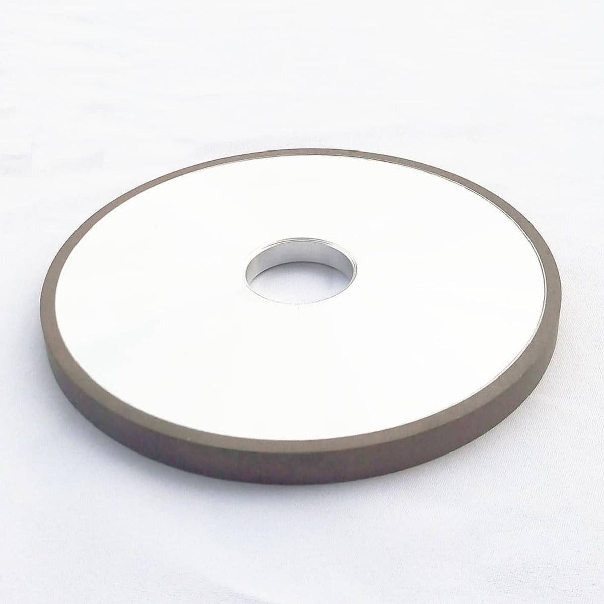 Diamond grinding wheel angled front view, 6-inch flat disc and center hole