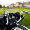 Chrome ape hanger handlebars installed on a touring motorcycle with instrument cluster