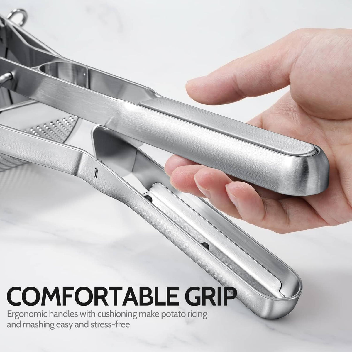 Stainless steel potato ricer with ergonomic grip handles and perforated ricing plate