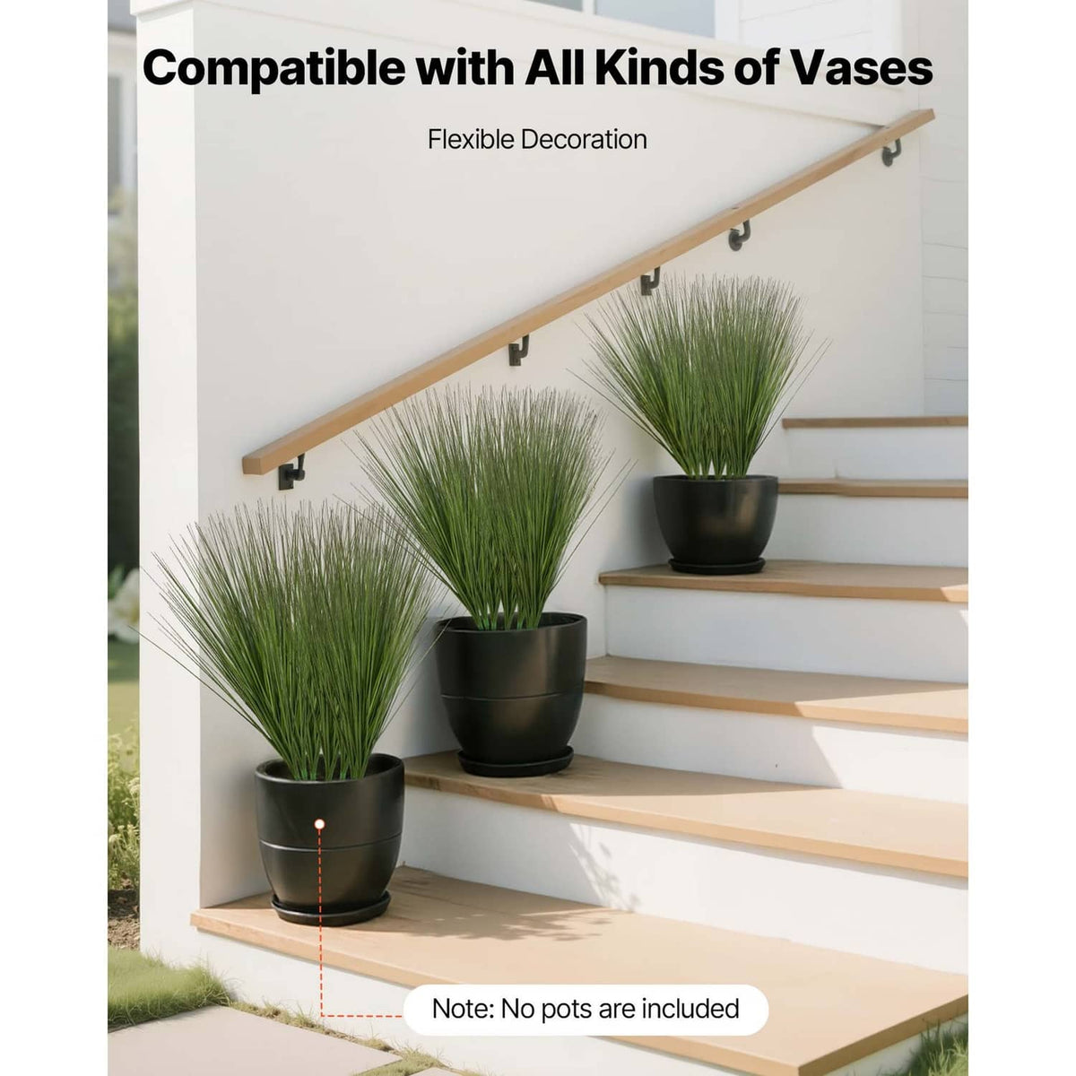 Artificial onion grass plant in black pots with long green blades on wall shelf