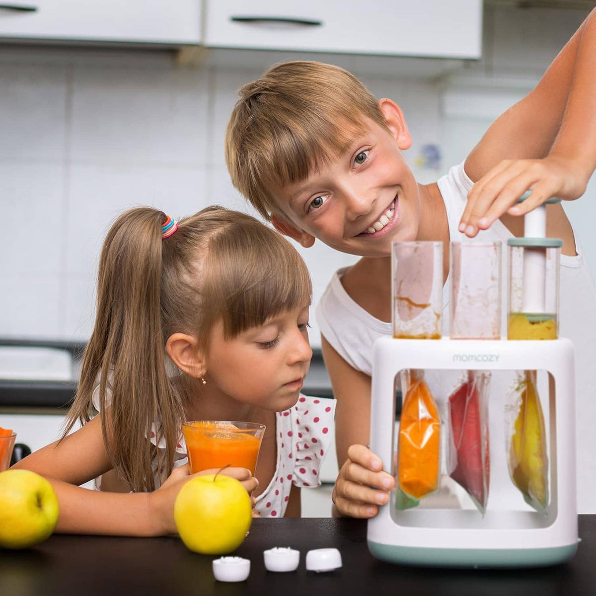 Baby food pouch filler squeeze station in a kitchen with two children
