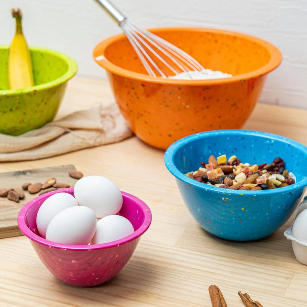 Confetti-speckled bowls, including blue bowl and pink bowl holding white eggs
