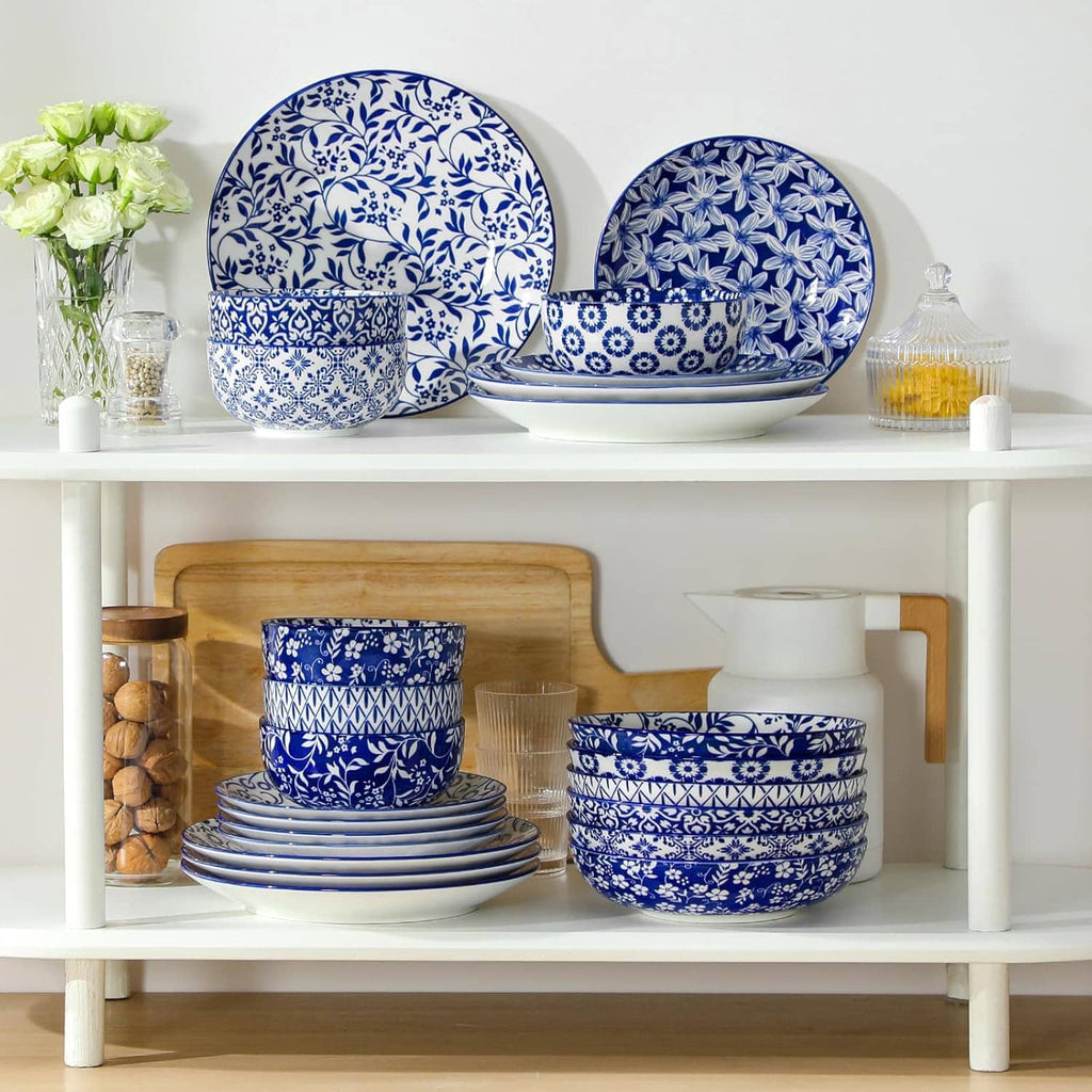 Blue-and-white patterned dinnerware set with stacked plates and bowls on a shelf