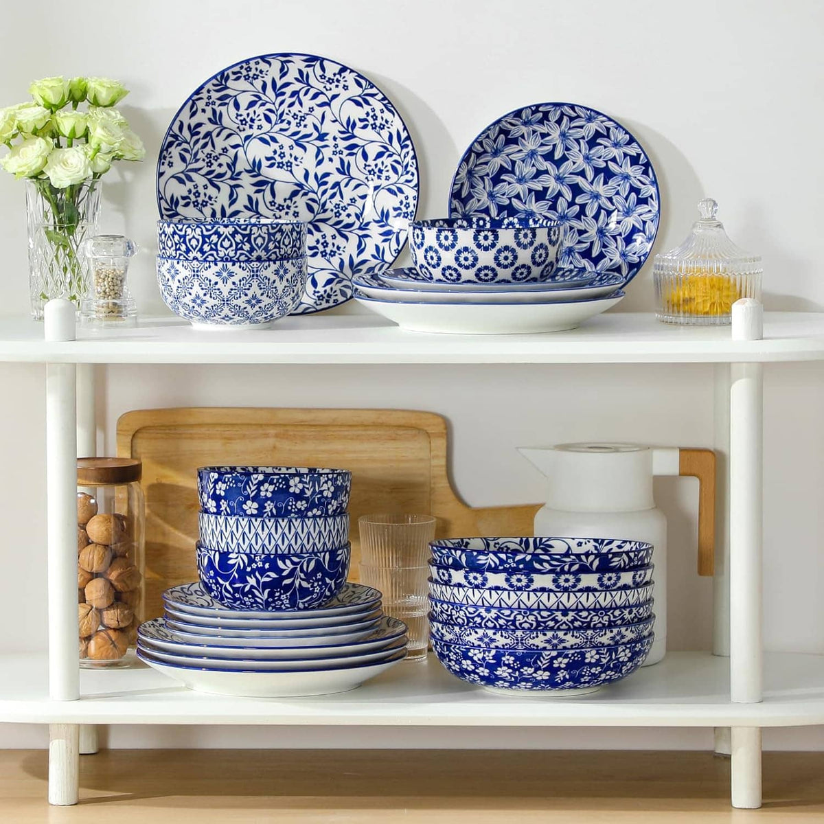 Blue-and-white patterned dinnerware set with stacked plates and bowls on a shelf