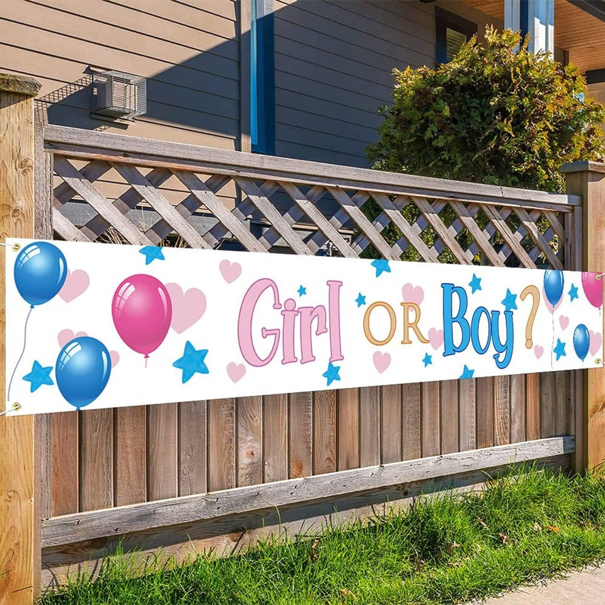 Gender reveal yard banner on fence with “Girl or Boy” text, pink hearts and blue stars