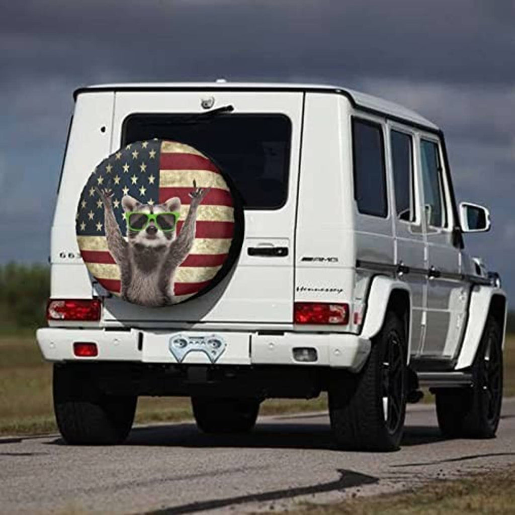 Raccoon-themed spare tire cover on a white RV rear door