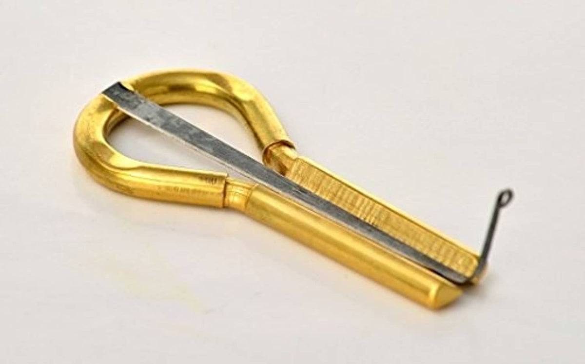 Gold metal jaw harp with grey tongue and looped frame, tuning tine included
