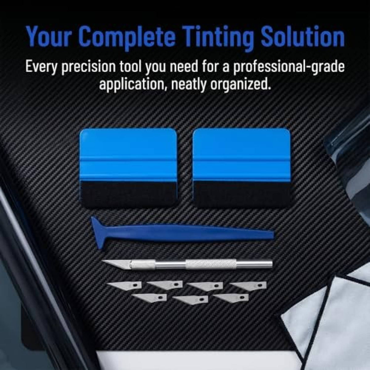 Window tinting tool kit laid out: blue felt squeegees, craft knife, and blades