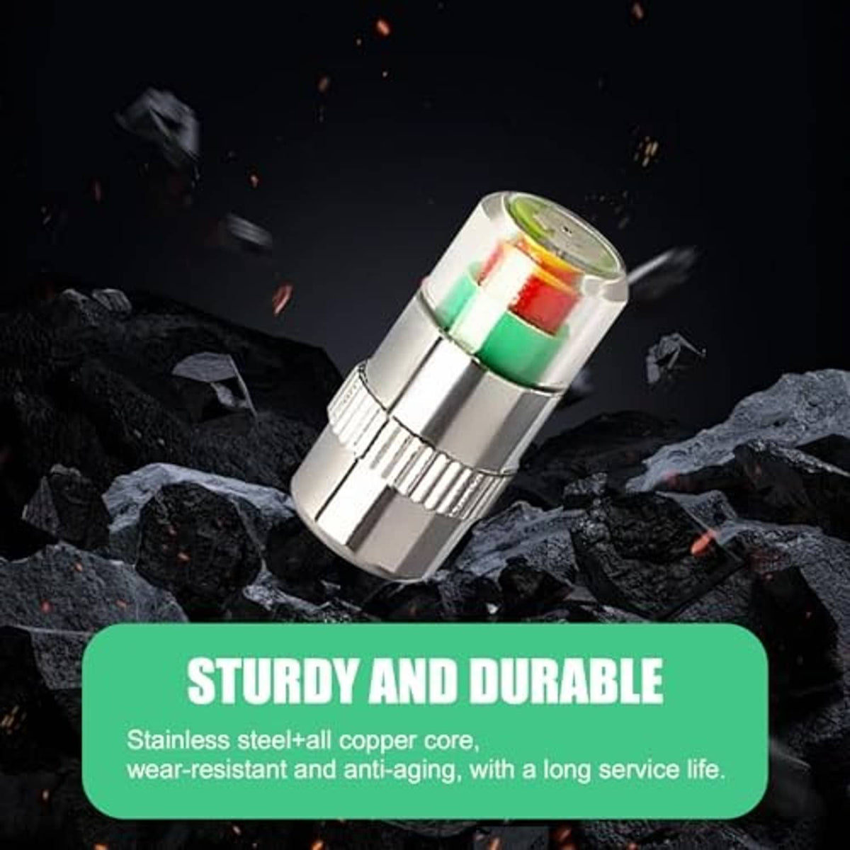Silver car tire valve stem cap with green red indicator ring on dark rocks