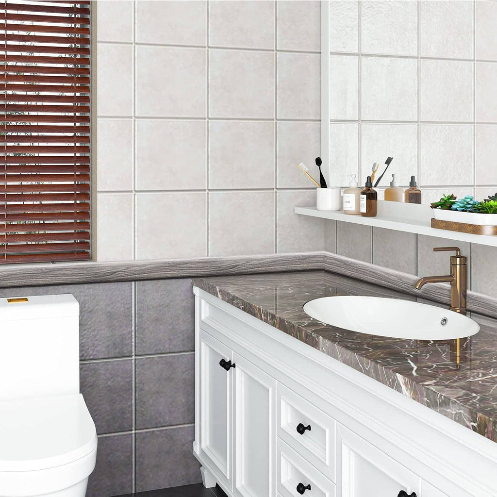 Gray woodgrain floor transition strip installed along tub and wall base