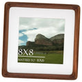 Walnut wood picture frame with white mat holding an 8x8 photo.