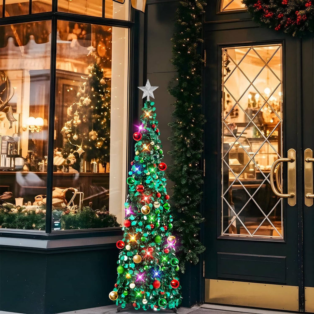 Prelit Christmas tree with star topper, green branches and glowing multicolor bulbs
