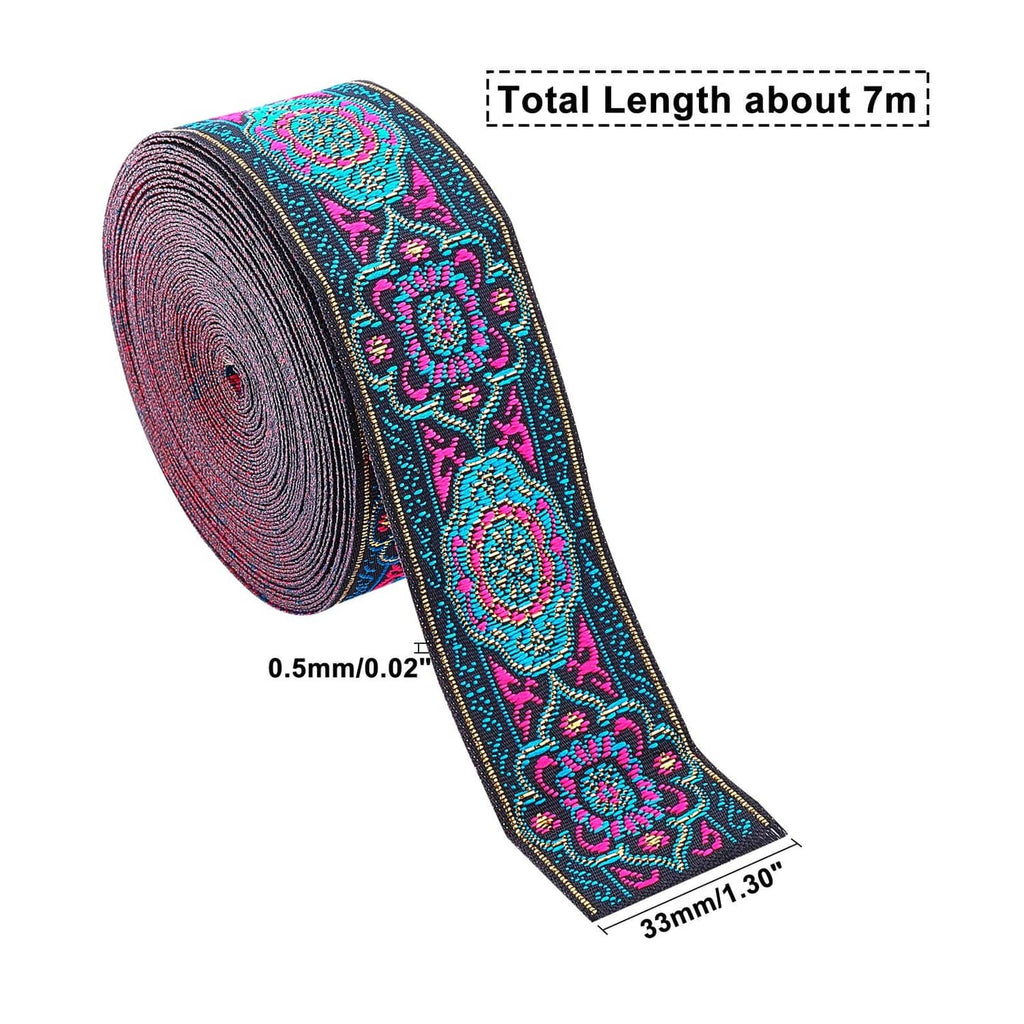 Embroidered jacquard ribbon on roll, teal and magenta floral design on dark background