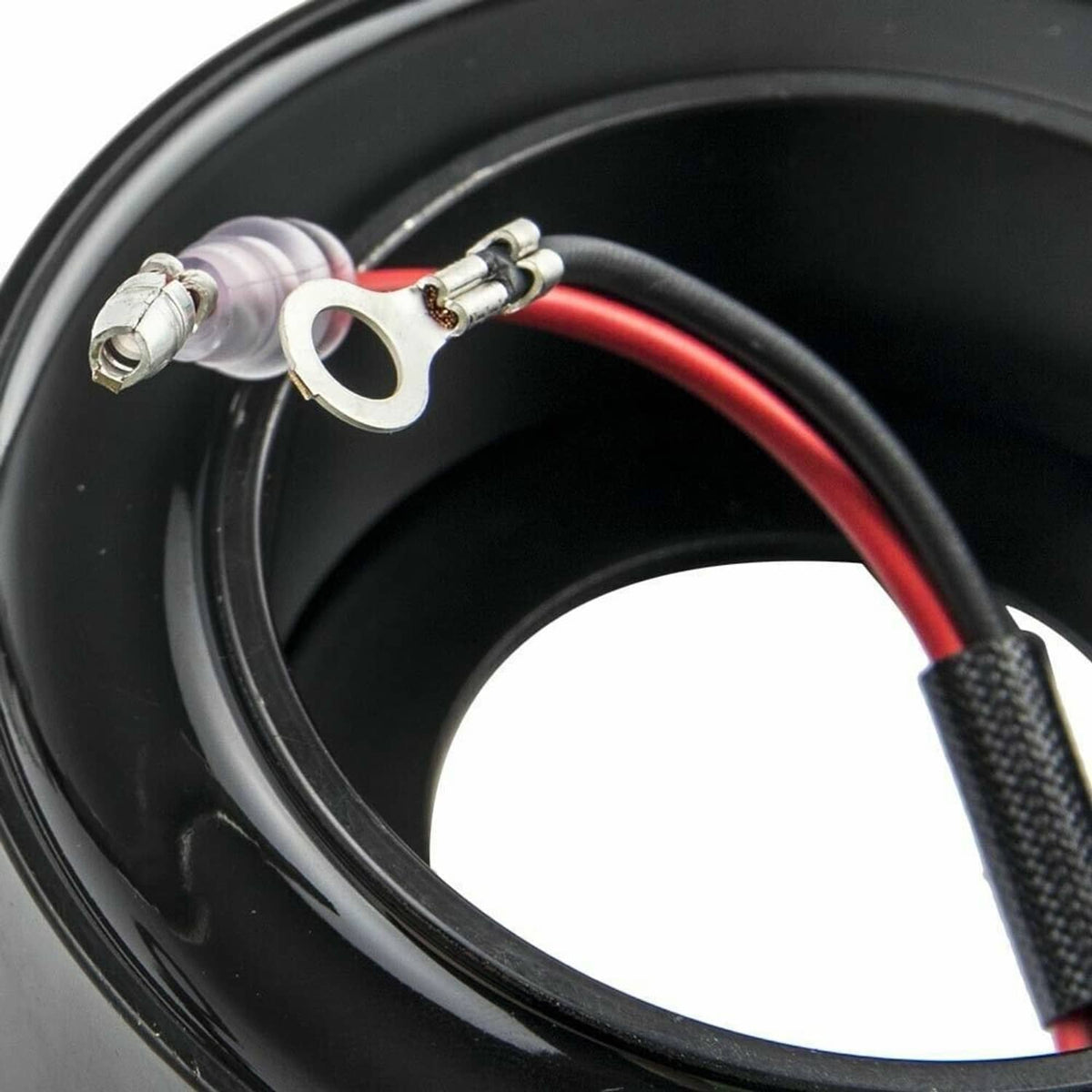 Close-up AC compressor clutch coil terminals with red and black wires on black housing