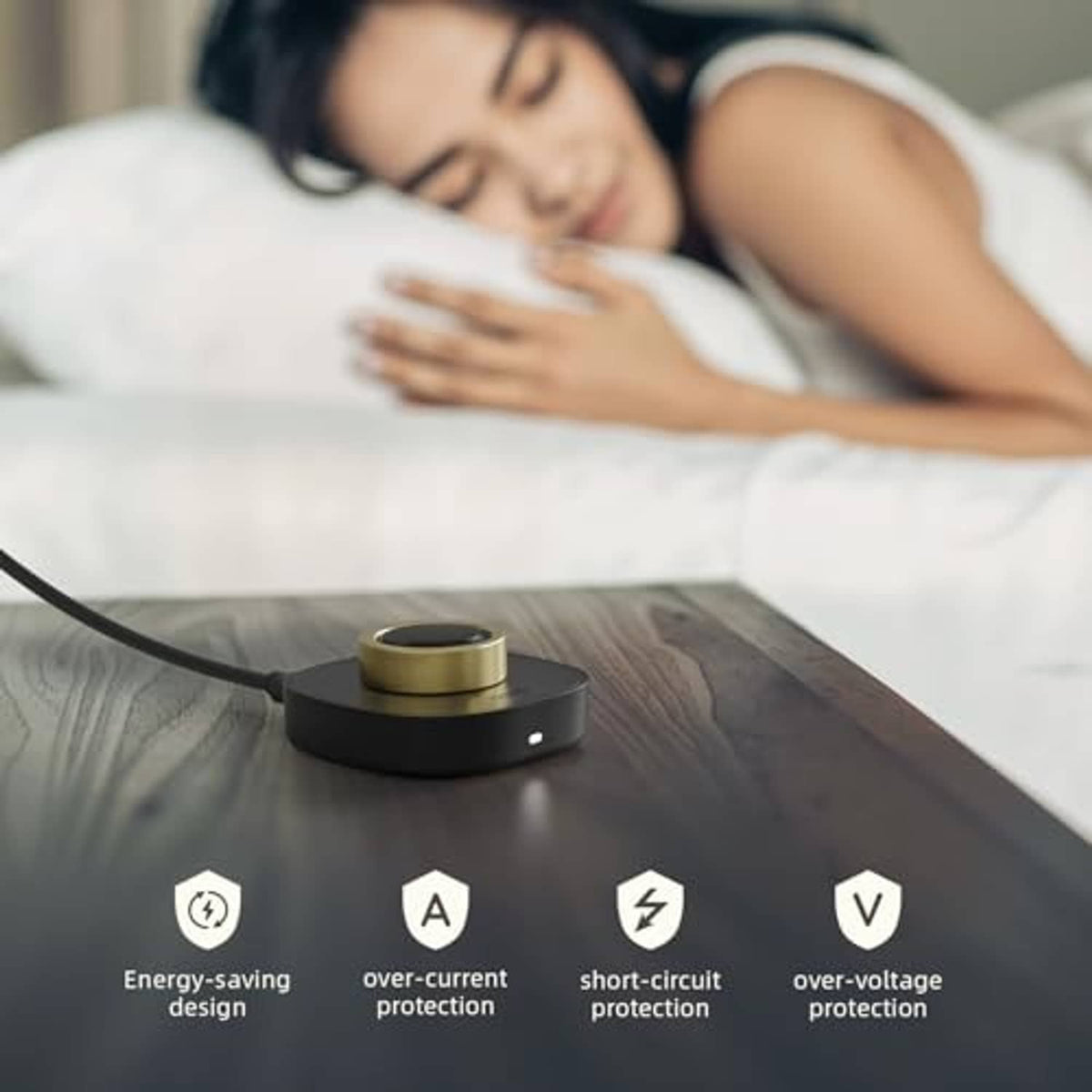 Black charging dock resting on a nightstand with charging cable connected