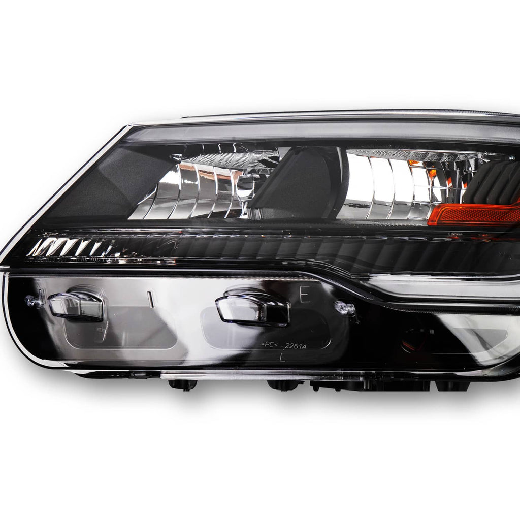 Black headlight assembly close-up with clear lens and amber reflector in projector housing