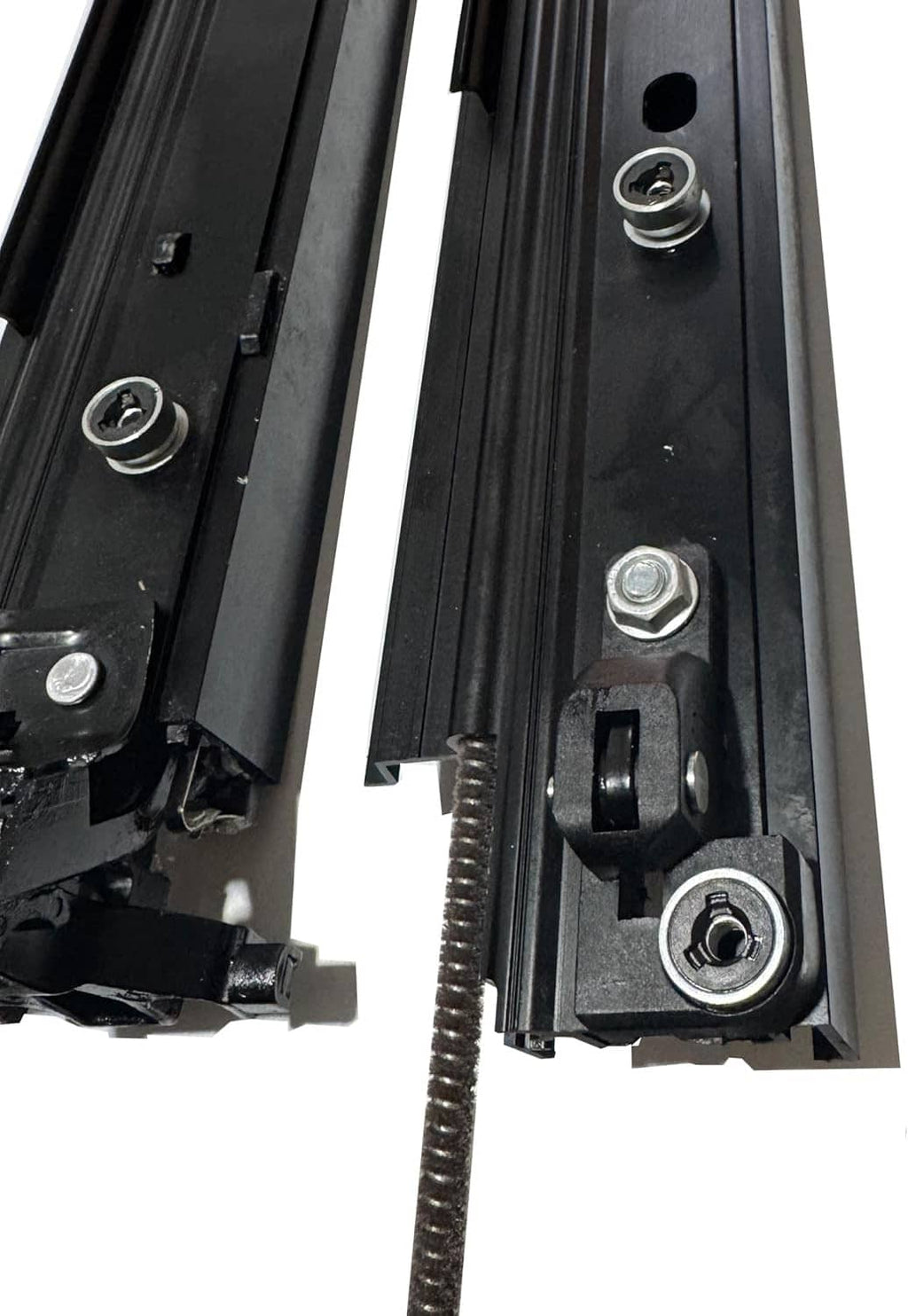 Close-up of black sunroof sliding track components with bolts, spring, and mounting plates