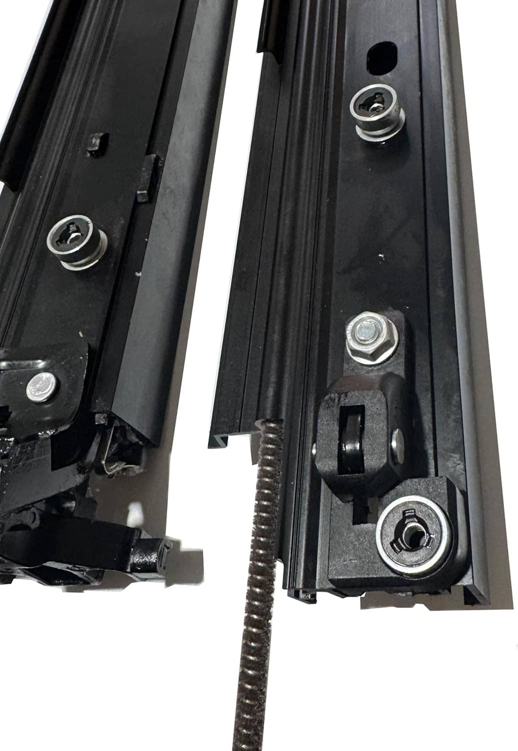 Close-up of black sunroof sliding track components with bolts, spring, and mounting plates