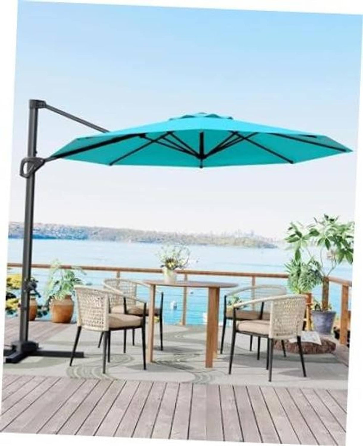Turquoise cantilever patio umbrella with open canopy, standing on a dark base stand.