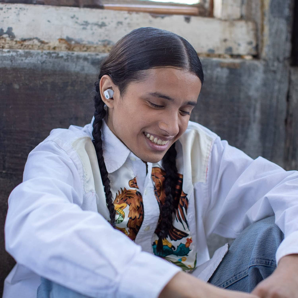 White true wireless earbuds in a person's ear, slim stemless fit