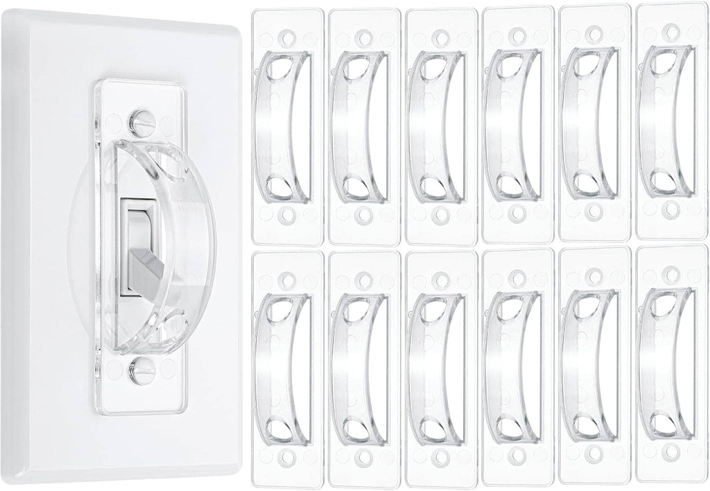 Clear toggle light switch guard covers shown on a white backing plate and extra units