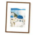 Walnut wood picture frame holding a landscape photo behind clear tempered glass