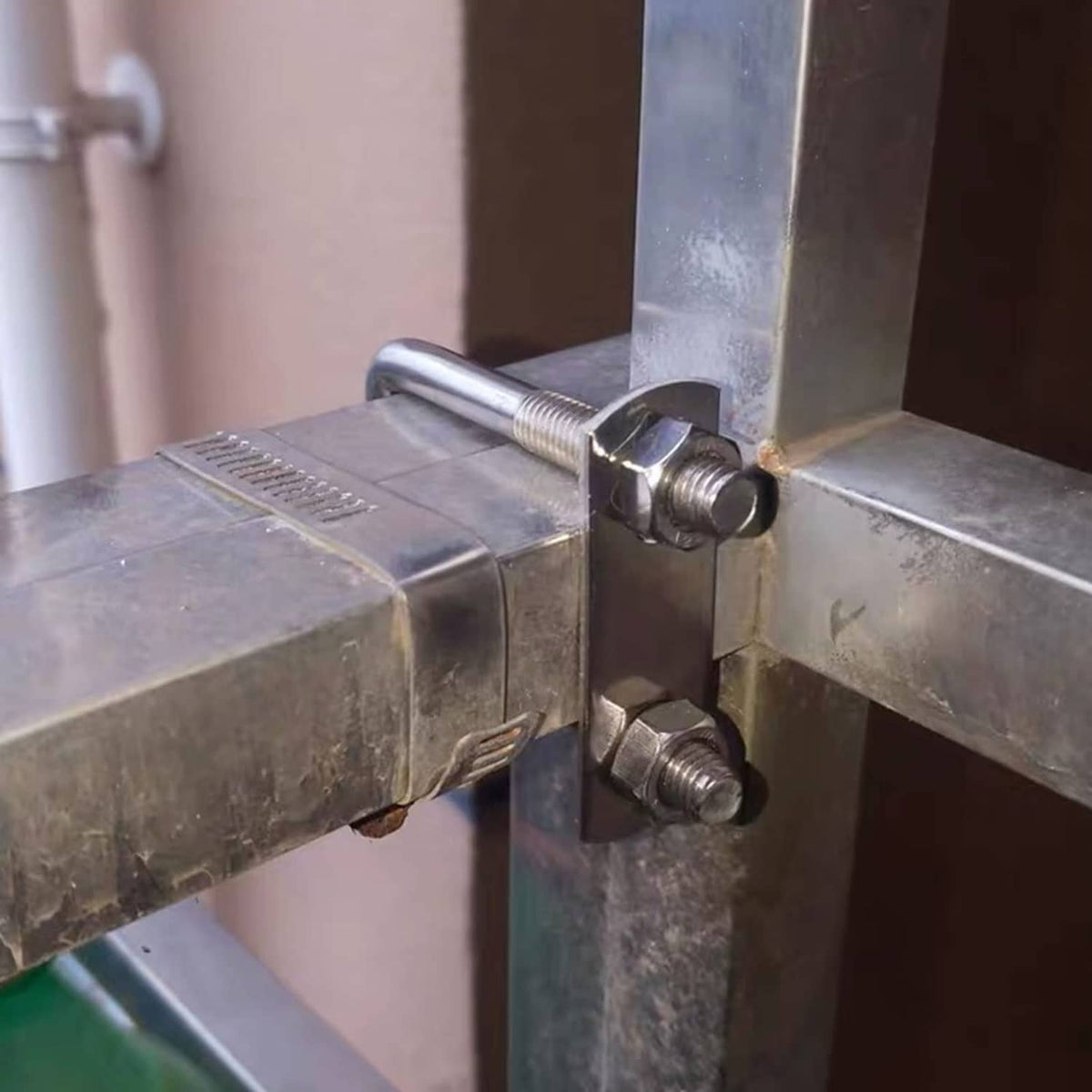 Stainless square U-bolt fastening metal beams with nuts and washers