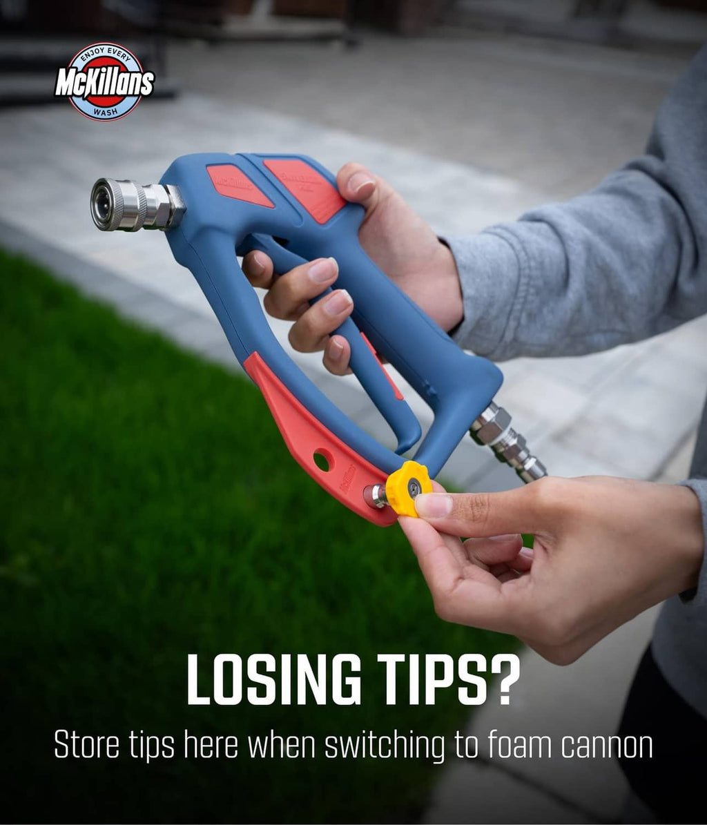 Blue and red pressure washer swivel gun with brass fittings in a hand
