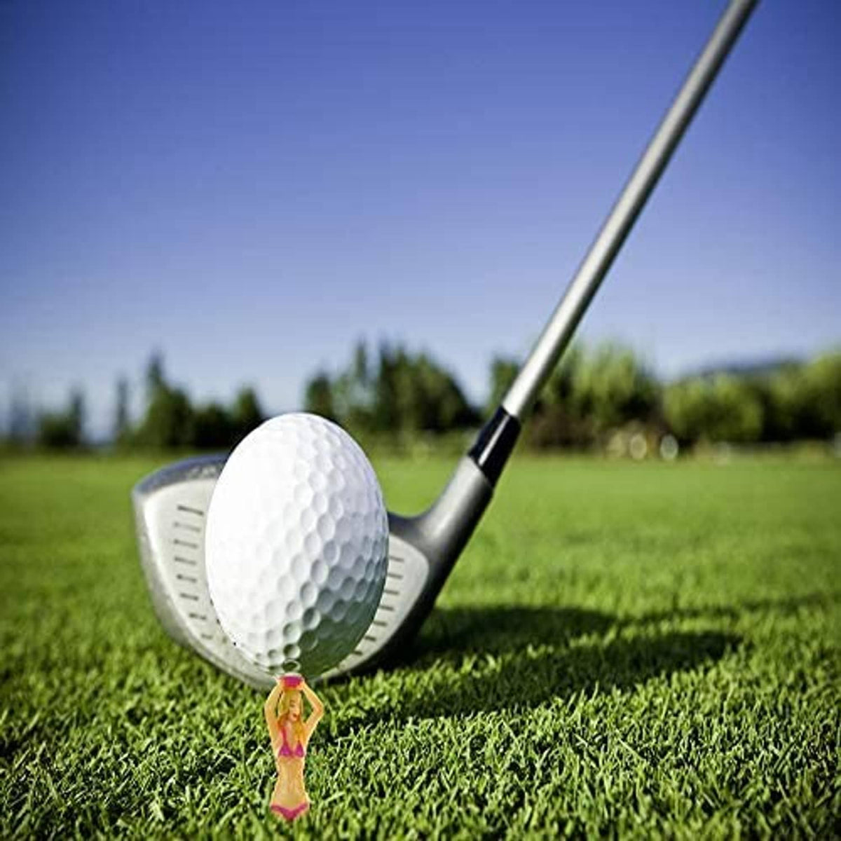Golf tee with white ball head and small red bikini figurine on green turf