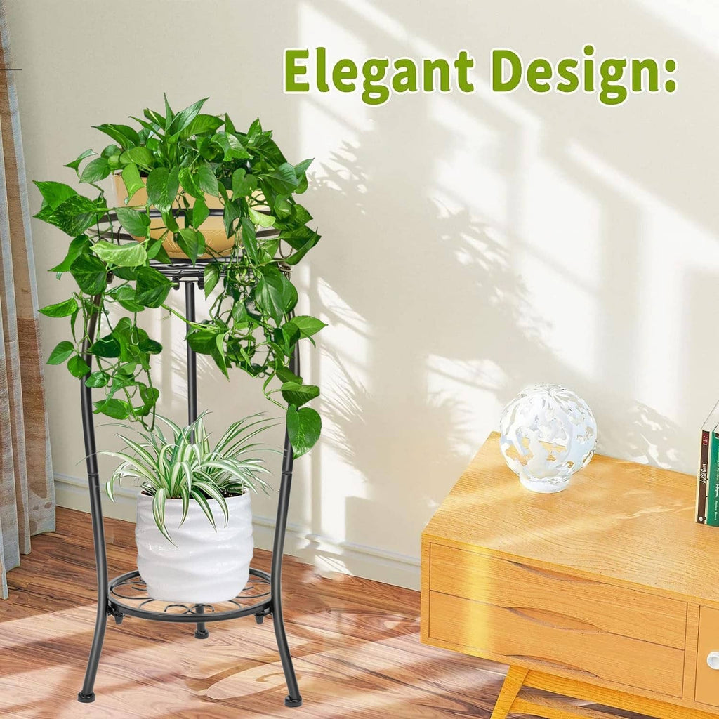 Black 2-tier metal plant stand with decorative scroll base and potted greenery