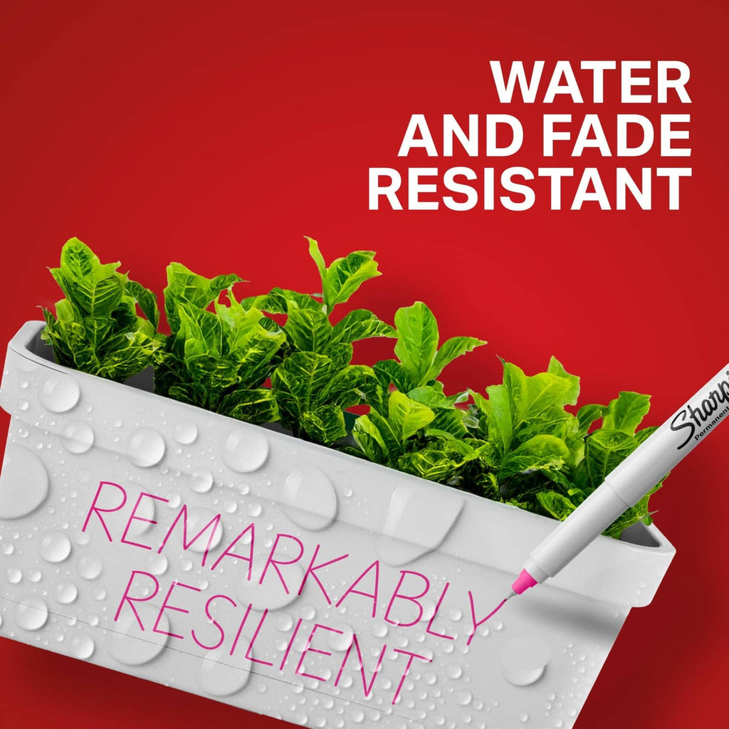 White Sharpie permanent marker with fine tip near a plant-filled tray