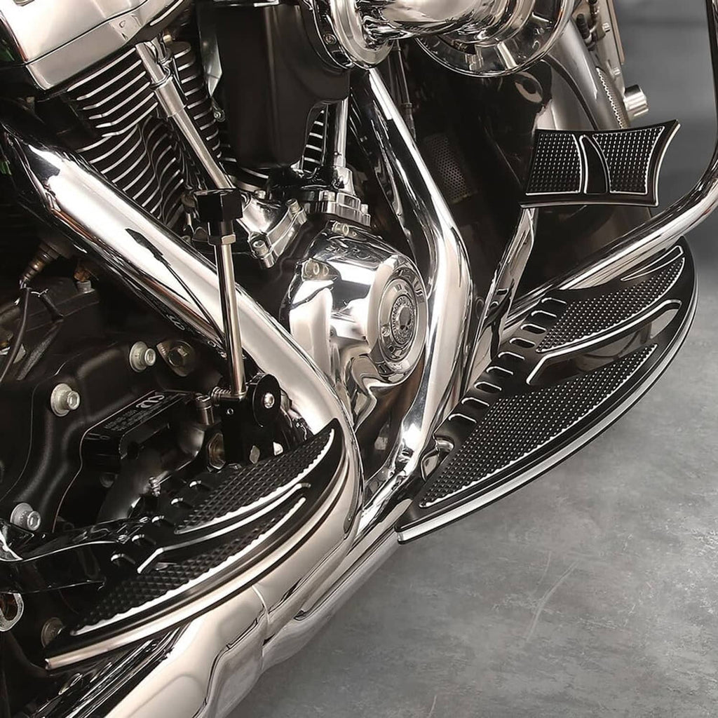 Mounted black textured motorcycle floorboard with silver accent on the side panel