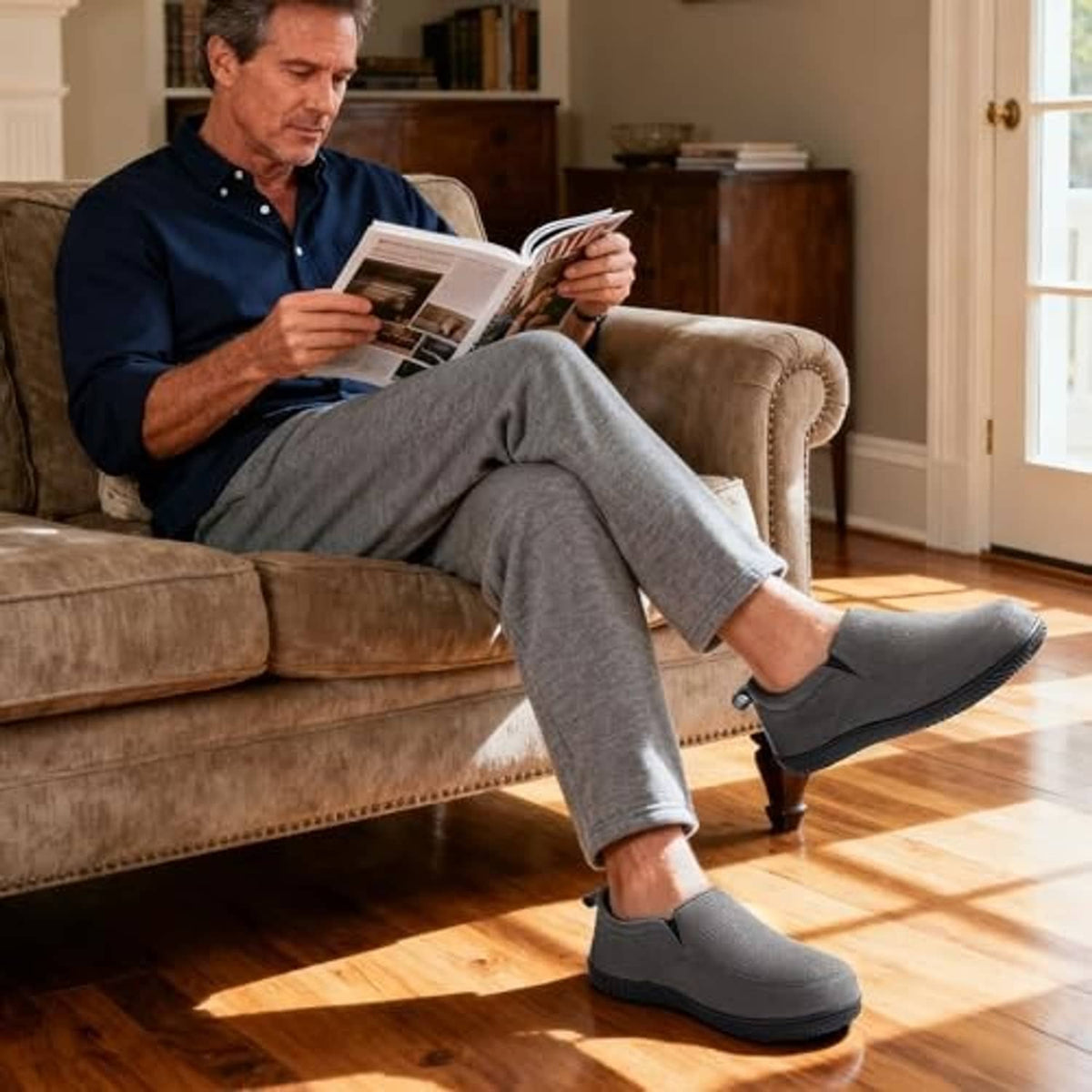 Charcoal closed-back memory foam slippers worn by a man with plush inner lining.