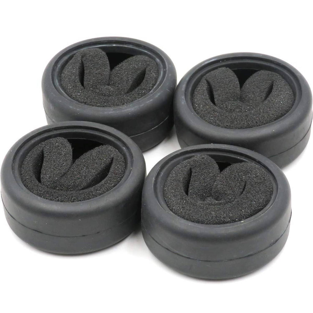 Four black RC on-road slick tires with foam inserts arranged in a cluster