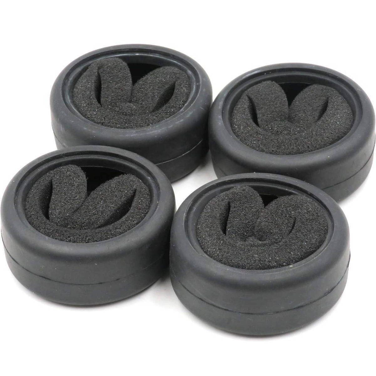 Four black RC on-road slick tires with foam inserts arranged in a cluster