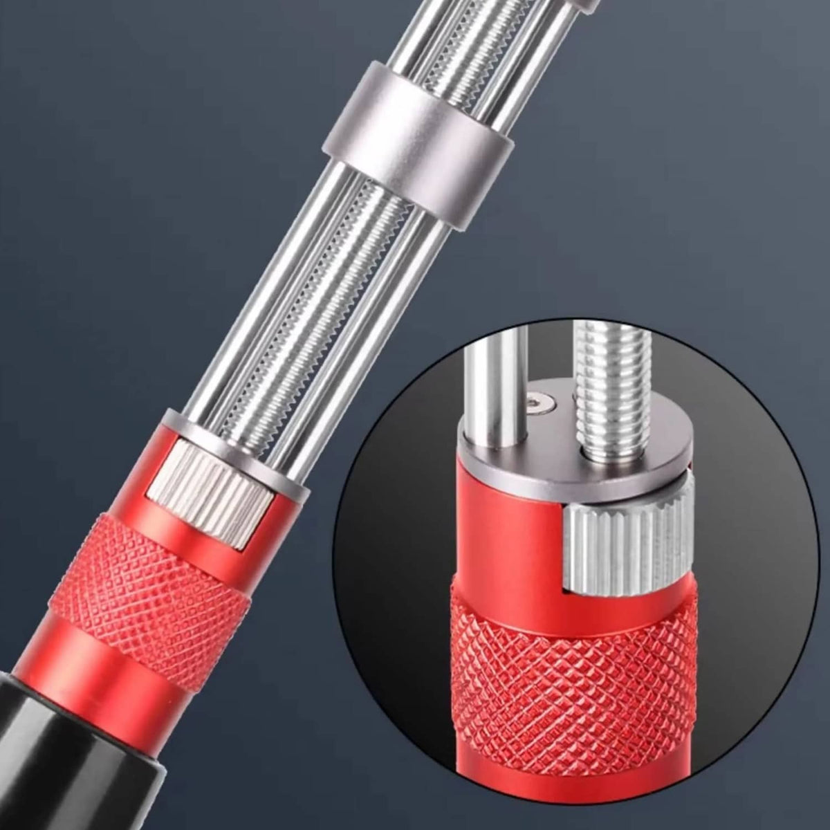 Adjustable watch back opener tool close-up: steel prongs, red textured grip