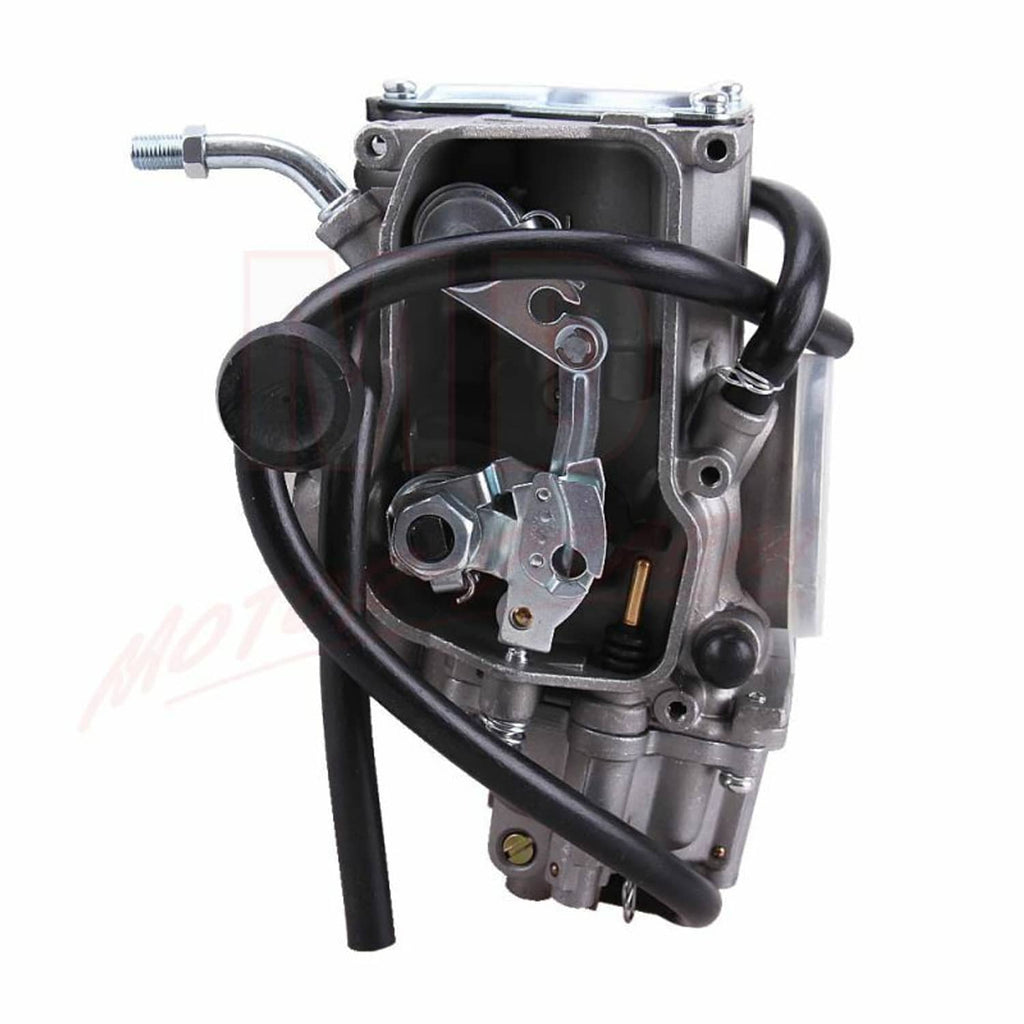 Carburetor body close-up with black hoses and fuel fitting